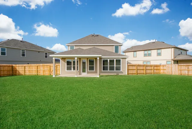 a view of a house with a backyard