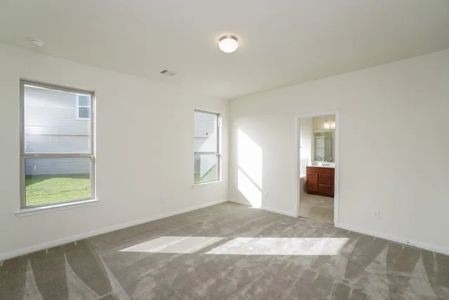 an empty room with windows and closet