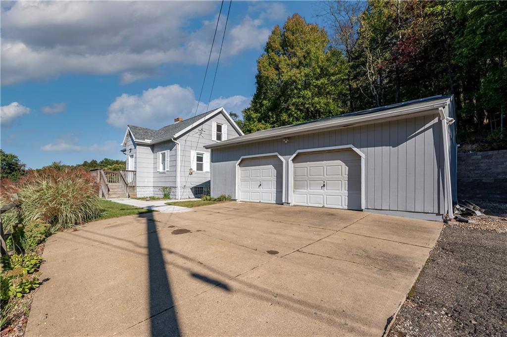 825 Reno Street Rochester, PA 15074 - Photo 2 of 23 a front view of a house with a yard and garage