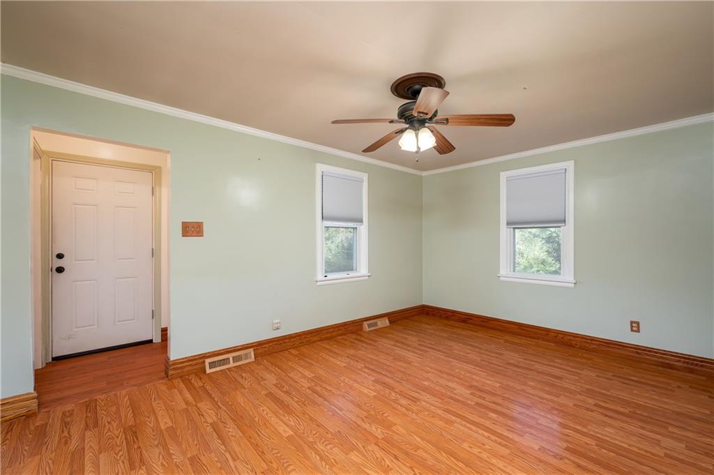 825 Reno Street Rochester, PA 15074 - Photo 3 of 23 a view of empty room with wooden floor and fan