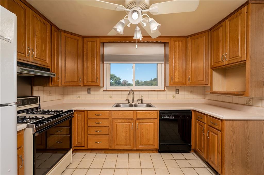 825 Reno Street Rochester, PA 15074 - Photo 8 of 23 a kitchen with a sink stove top oven and cabinets