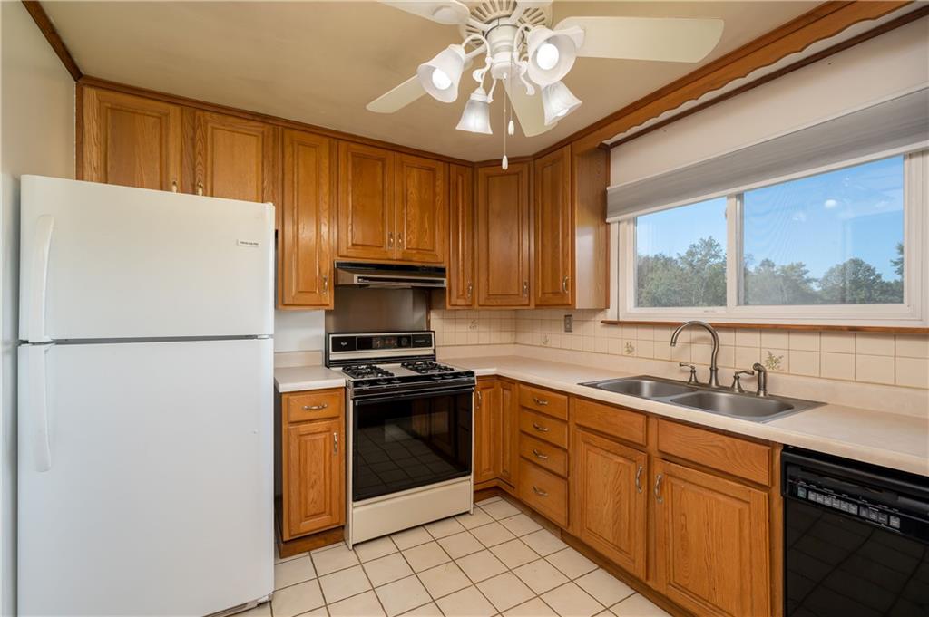 825 Reno Street Rochester, PA 15074 - Photo 9 of 23 a kitchen with stainless steel appliances granite countertop a refrigerator sink stove microwave and cabinets