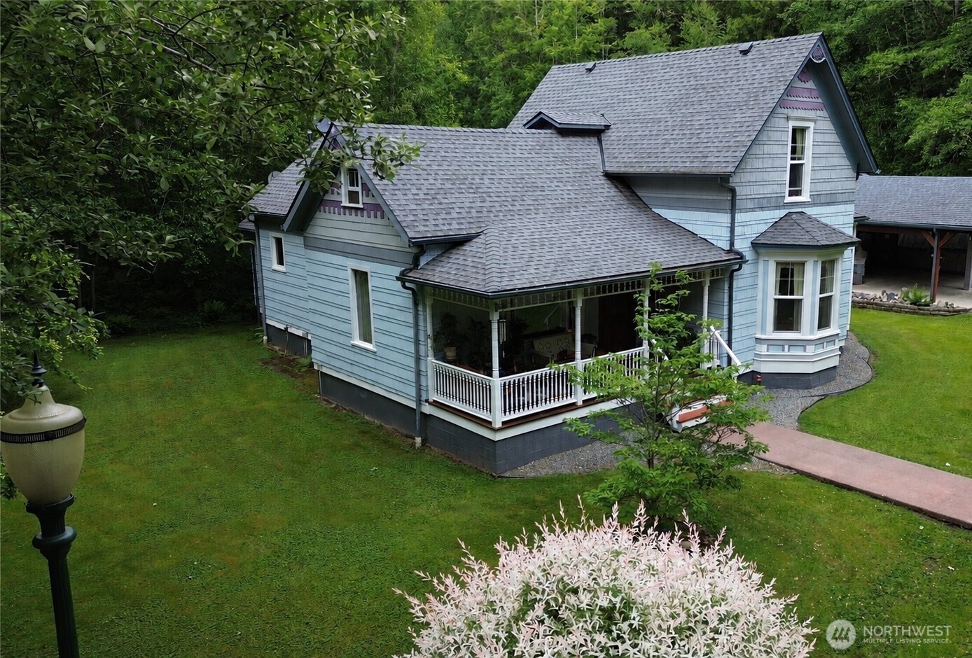 2909 Overpass Road Bow, WA 98232 - Photo 1 of 40 a aerial view of a house with a yard table and chairs