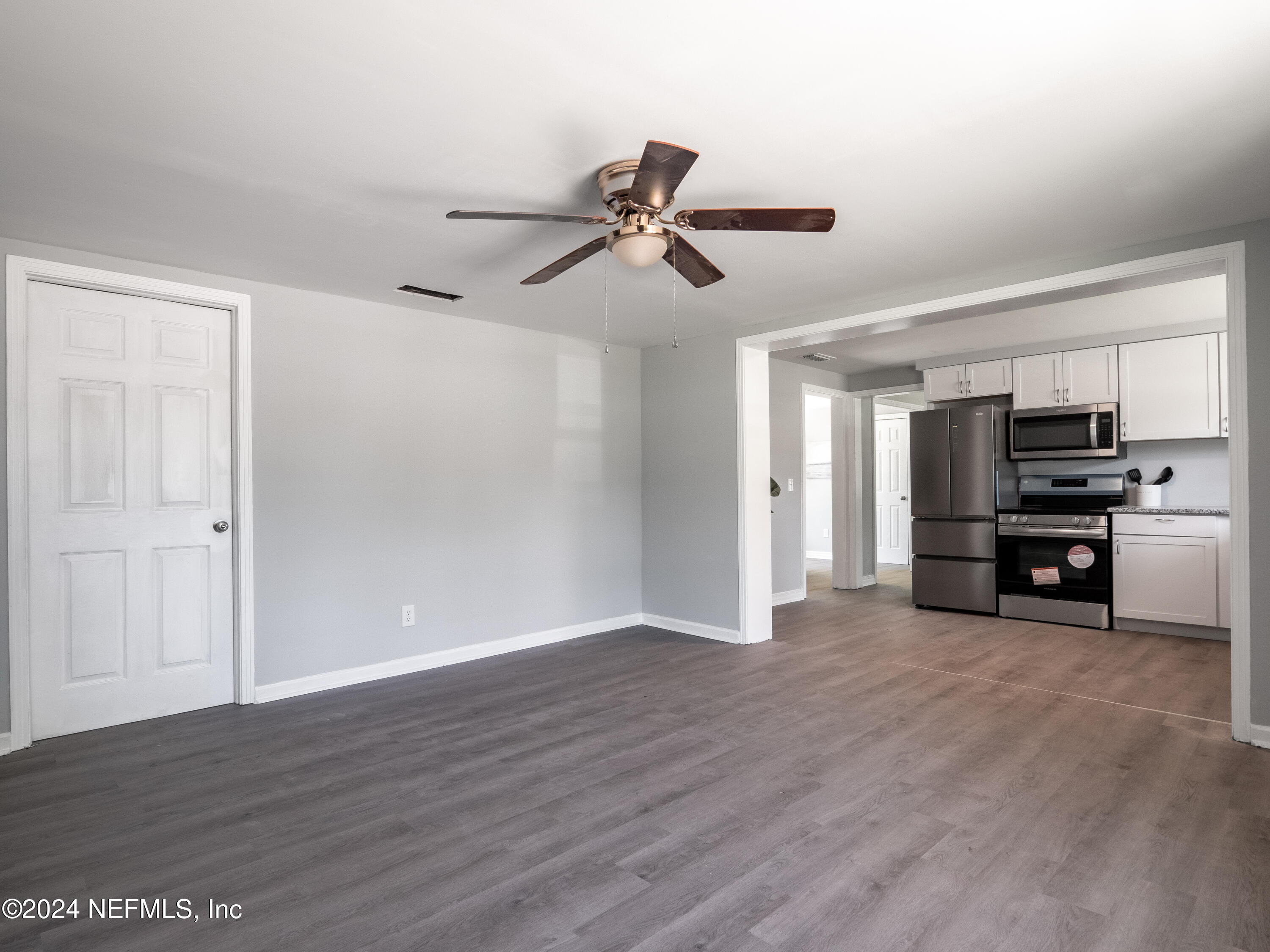 4255 Glenview Road Jacksonville, FL 32207 - Photo 18 of 24 a view of a kitchen with furniture a ceiling fan and wooden floor
