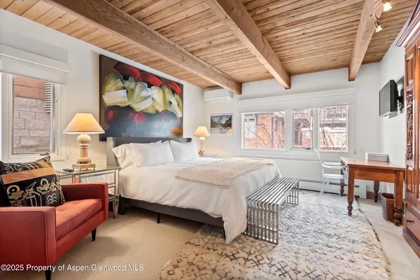 a bedroom with a bed a bookshelf and a couch