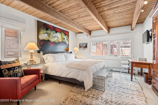 a bedroom with a bed a bookshelf and a couch