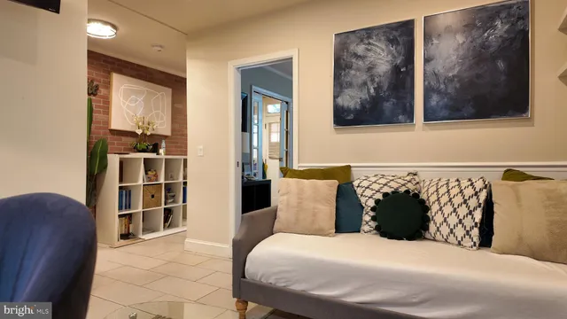 a bedroom with a bed and painting on the wall