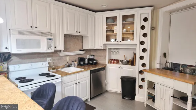 a kitchen with stainless steel appliances granite countertop a stove and a refrigerator