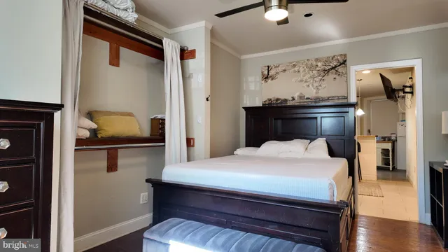 a bedroom with a bed and wooden floor