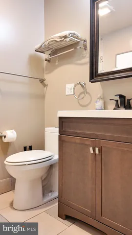 a white toilet sitting next to a bathroom sink