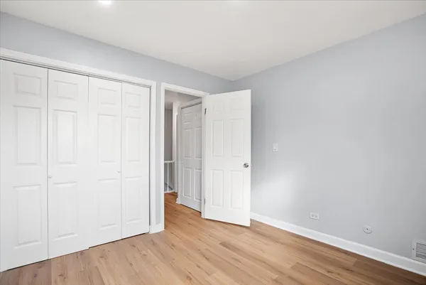a view of an empty room and wooden floor