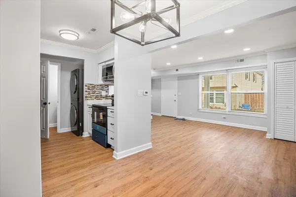 a view of empty room with wooden floor and fireplace