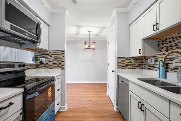a kitchen with stainless steel appliances granite countertop a stove and a sink