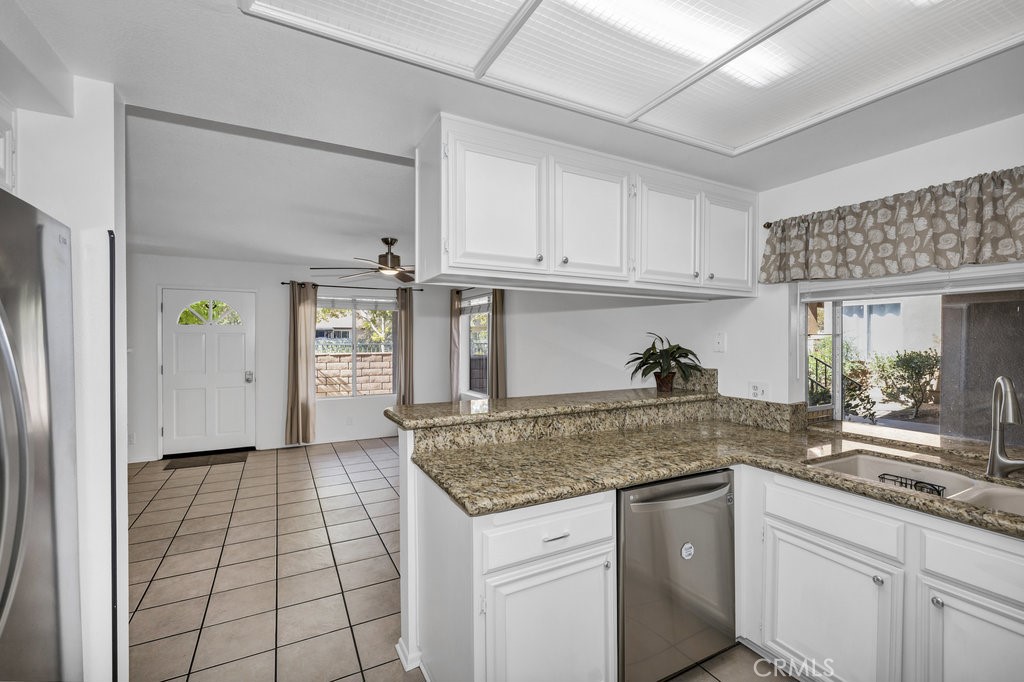28114 Seco Canyon Road, Unit 156 Saugus, CA 91390 - Photo 11 of 31 a kitchen with granite countertop a sink and cabinets