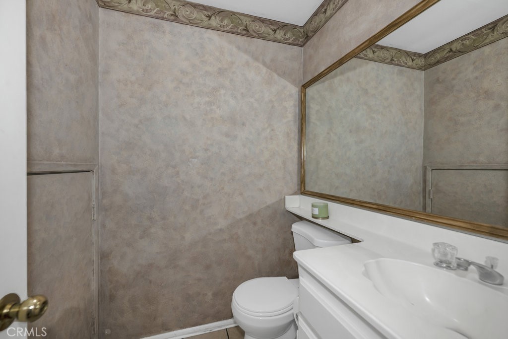 28114 Seco Canyon Road, Unit 156 Saugus, CA 91390 - Photo 13 of 31 a white toilet sitting next to a bathroom sink