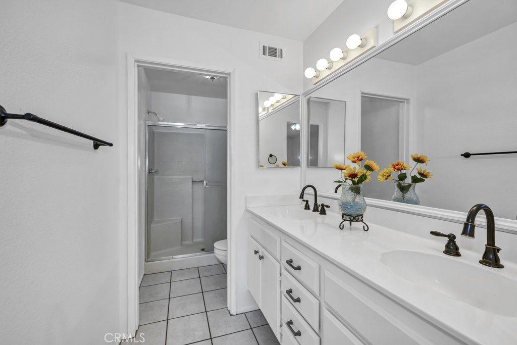 28114 Seco Canyon Road, Unit 156 Saugus, CA 91390 - Photo 17 of 31 a bathroom with a double vanity sink mirror and shower
