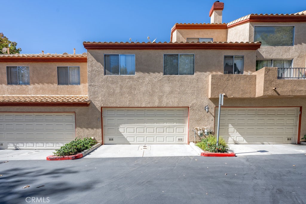 28114 Seco Canyon Road, Unit 156 Saugus, CA 91390 - Photo 2 of 31 front view of a house with a yard