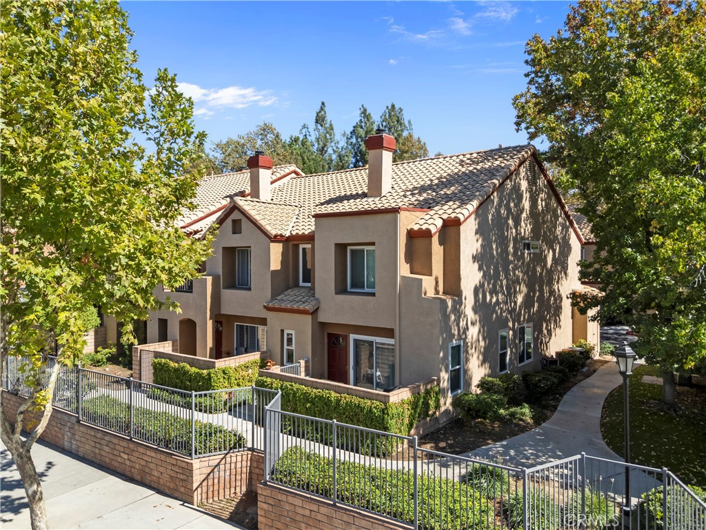28114 Seco Canyon Road, Unit 156 Saugus, CA 91390 - Photo 27 of 31 a front view of a house with plants