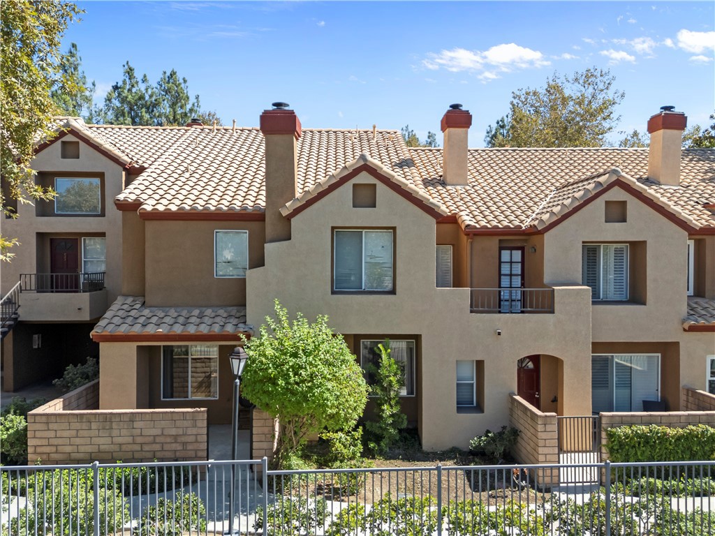 28114 Seco Canyon Road, Unit 156 Saugus, CA 91390 - Photo 28 of 31 a front view of a house with a garden