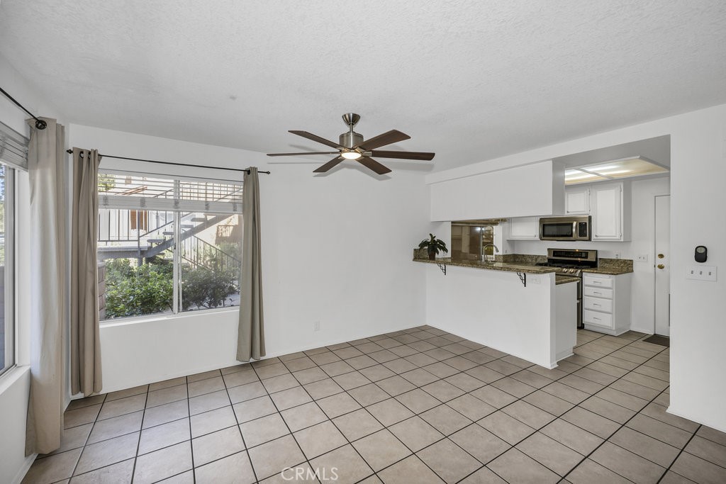 28114 Seco Canyon Road, Unit 156 Saugus, CA 91390 - Photo 7 of 31 a kitchen with a refrigerator and white cabinets
