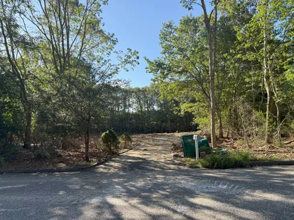 a front view of a house with a yard garden and plants