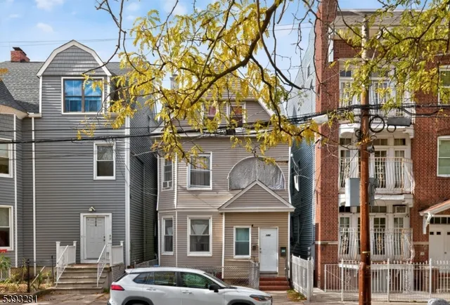 a front view of a residential apartment building with a yard