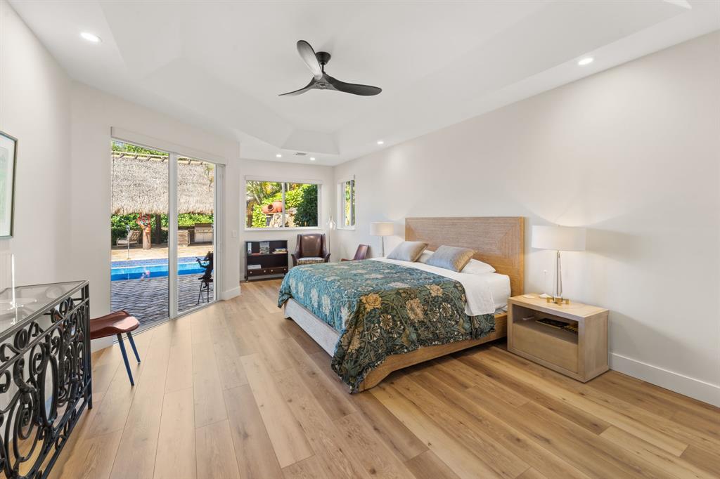 10171 Northwest 59th Drive Parkland, FL 33076 - Photo 11 of 49 a bedroom with a bed and wooden floor