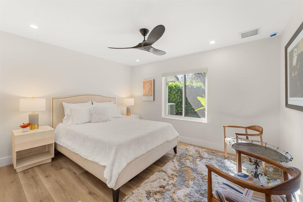 10171 Northwest 59th Drive Parkland, FL 33076 - Photo 32 of 49 a bedroom with a bed and a table in it