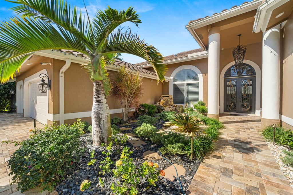 10171 Northwest 59th Drive Parkland, FL 33076 - Photo 35 of 49 a front view of a house with a yard