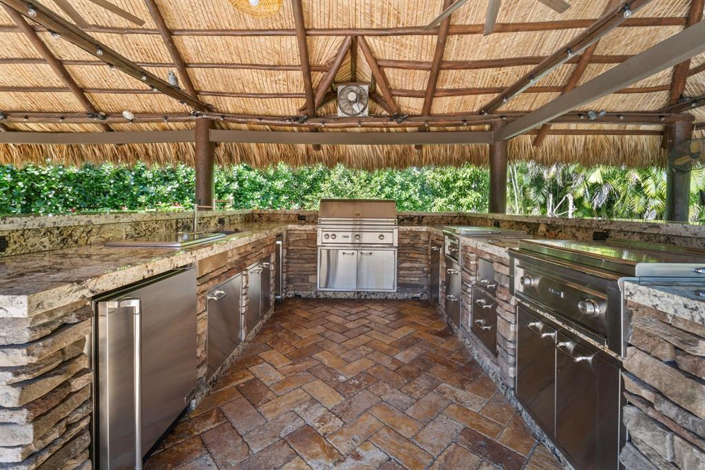 10171 Northwest 59th Drive Parkland, FL 33076 - Photo 48 of 49 a kitchen with stainless steel appliances granite countertop a stove a sink and dishwasher