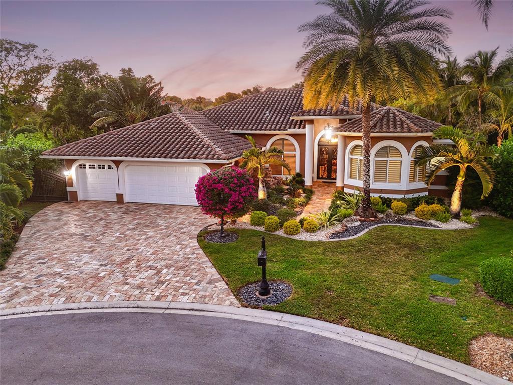 10171 Northwest 59th Drive Parkland, FL 33076 - Photo 5 of 49 a view of a house with a yard and potted plants