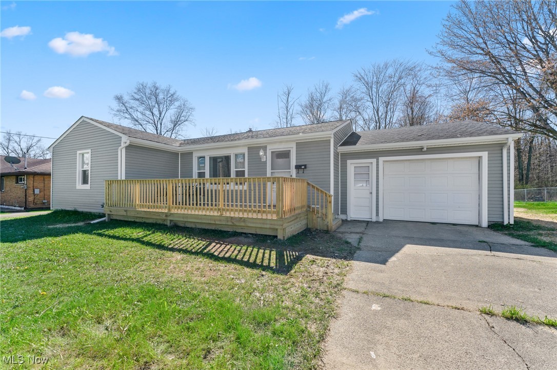 914 Pinecrest Road Girard, OH 44420 - Photo 23 of 24 Ranch-style house featuring a garage, a wooden deck, and a front lawn