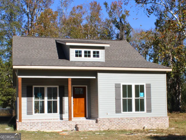 a house that has tree in front of it