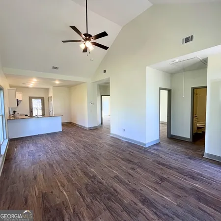 a view of a livingroom with a hardwood floor and a ceiling fan