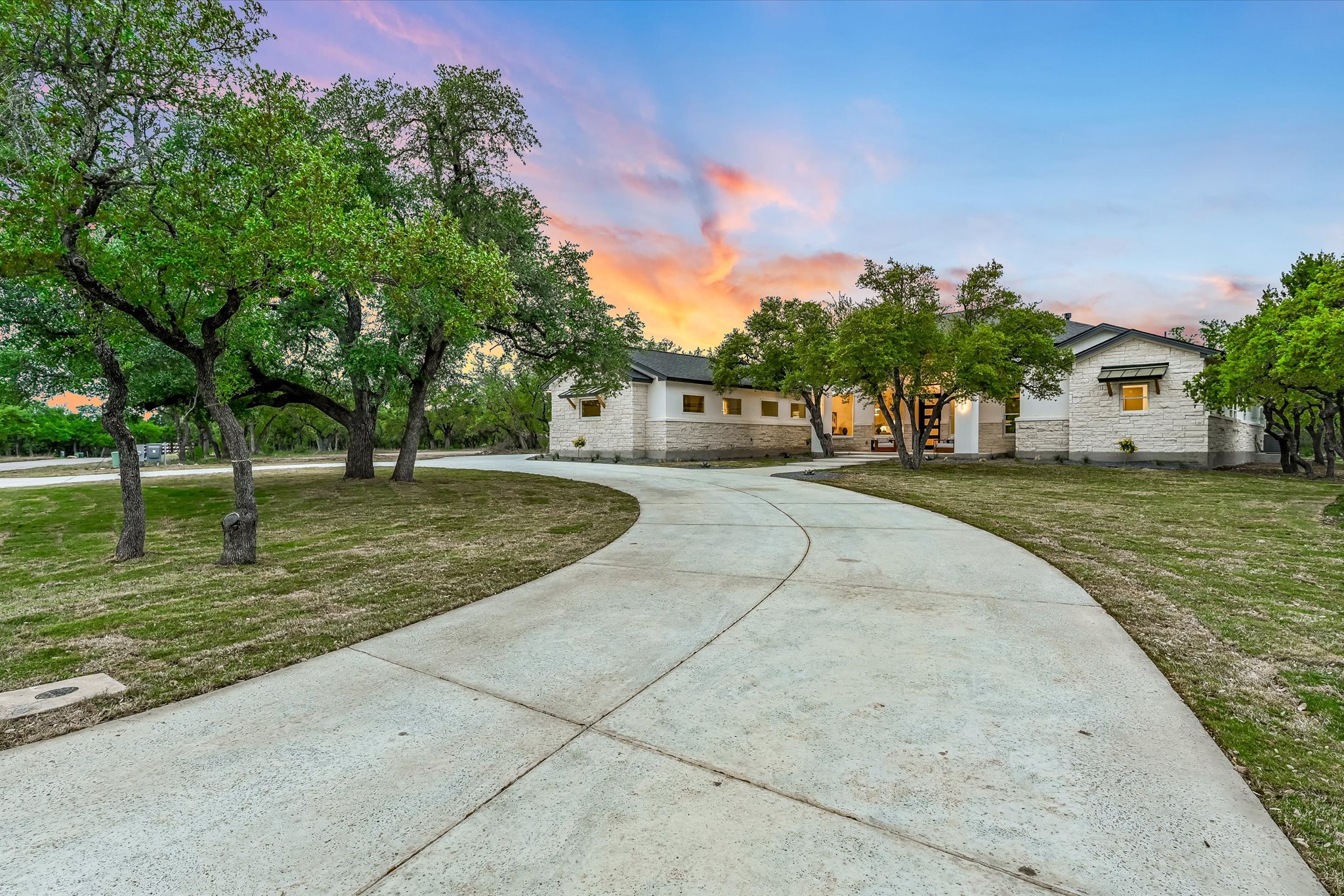 410 Shady Tree Drive Georgetown, TX 78633 - Photo 3 of 40 View of front of home featuring a front yard, curved driveway, and stone siding