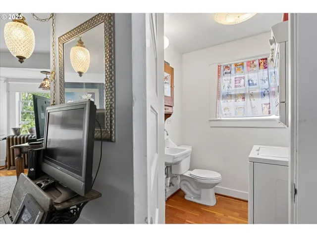 a bathroom with a toilet sink and mirror