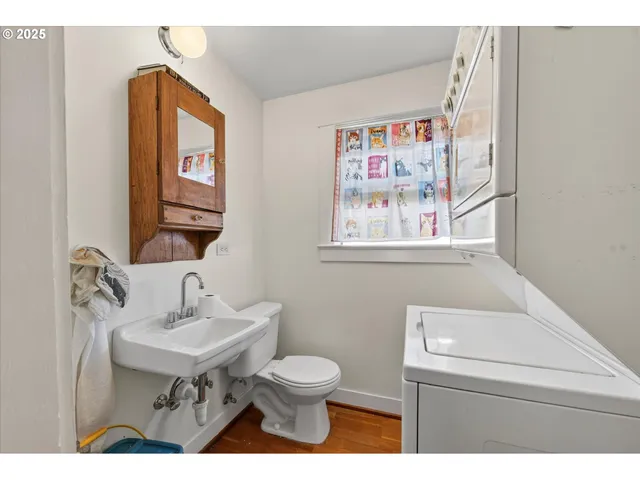 a bathroom with a toilet a sink and a mirror