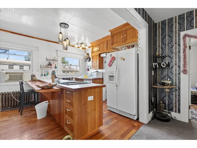 a kitchen with refrigerator and cabinets