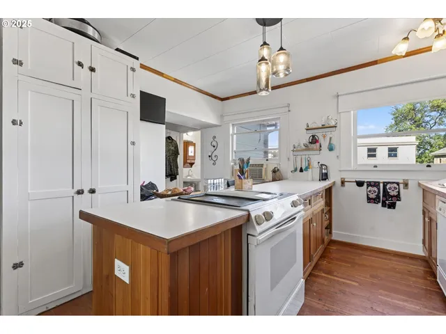 a kitchen with stainless steel appliances granite countertop a sink a stove and a refrigerator