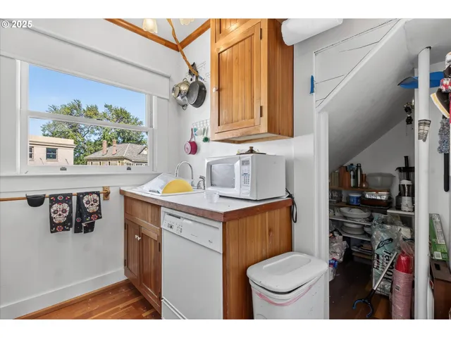 a kitchen with a stove a refrigerator and a sink
