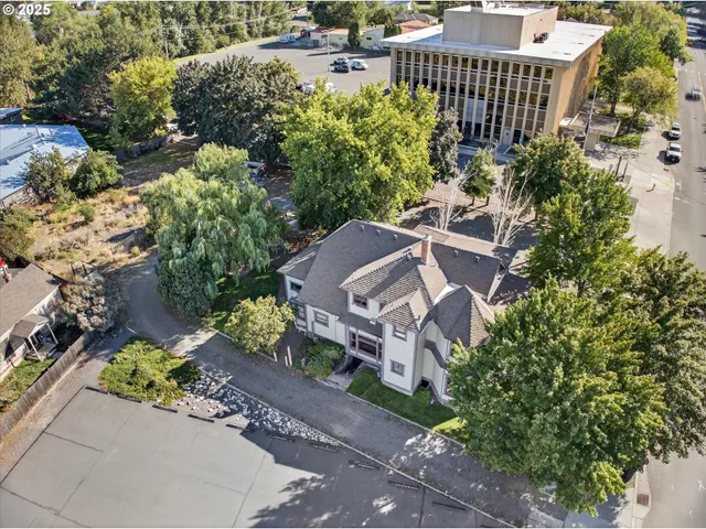 an aerial view of a house with a yard and garden