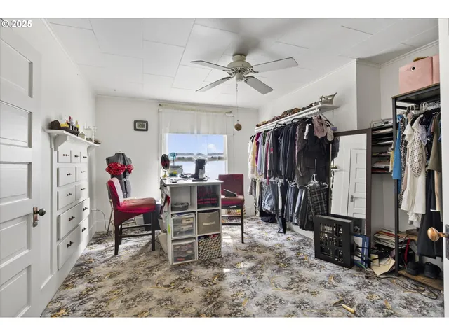 a living room with lots of furniture and a view of kitchen