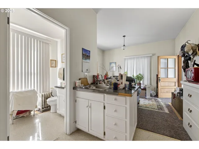 a living room with furniture a flat screen tv and a window