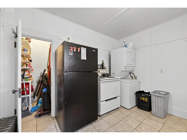 a kitchen with a refrigerator and a stove