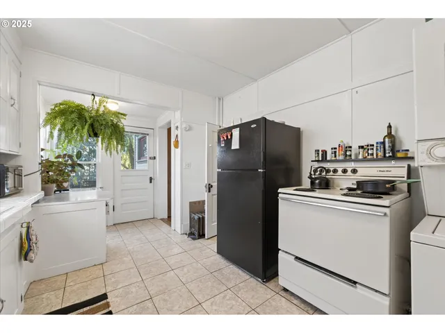 a kitchen with a refrigerator a stove a microwave and cabinets