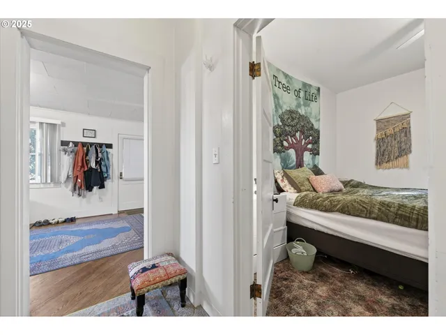 a living room with furniture and a painting on the wall