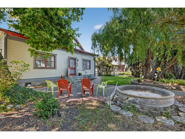 a view of a house with backyard sitting area and garden