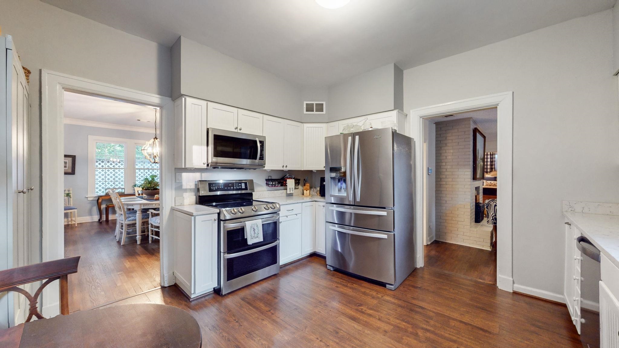 4572 Princeton Road Memphis, TN 38117 - Photo 5 of 36 a kitchen with a refrigerator stove and wooden floor