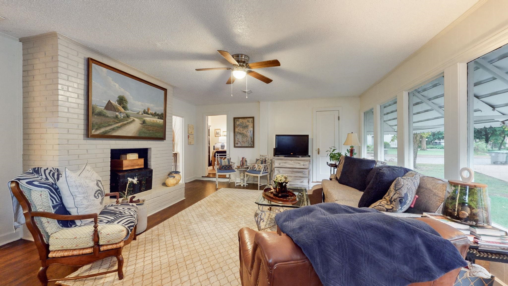 4572 Princeton Road Memphis, TN 38117 - Photo 7 of 36 a living room with furniture a fireplace and a flat screen tv