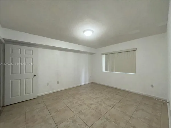 an empty room with a empty space and windows